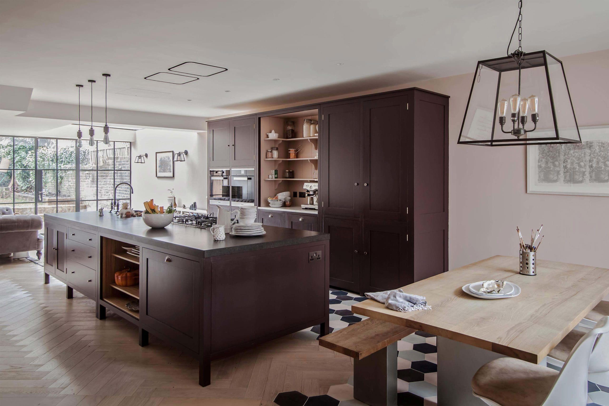  Modern Highbury Barn Kitchen with an Osea Island and honed Belgian Fossil Stone worktop. Bespoke Oak lined open shelving. Pull Out cupboard. Diresco Leather worktop.