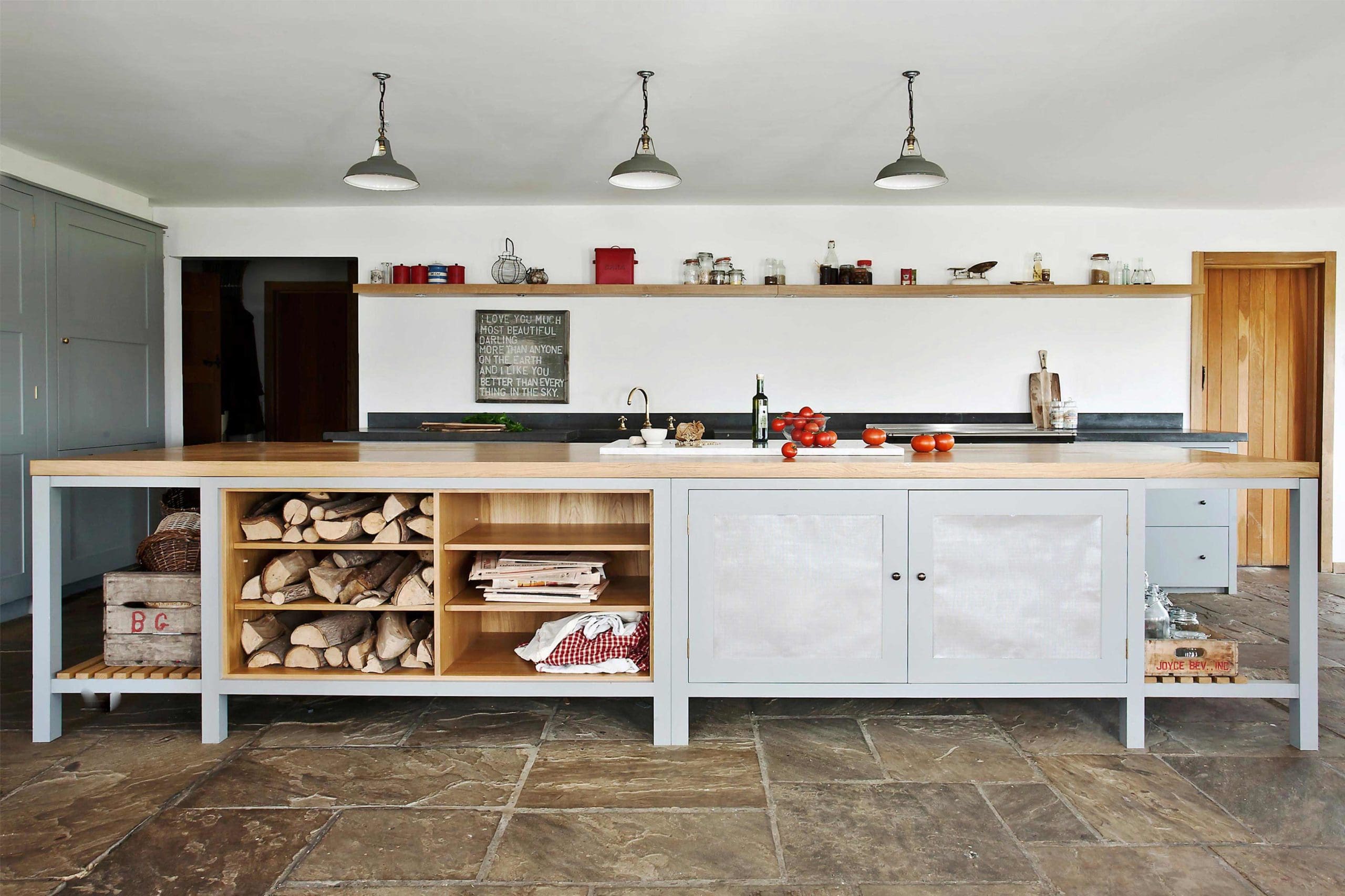  The Osea Island with open shelving and perforated zinc mesh doors In the Hampshire Hop Kiln kitchen with a thick rustic oak worktop. Hand painted.