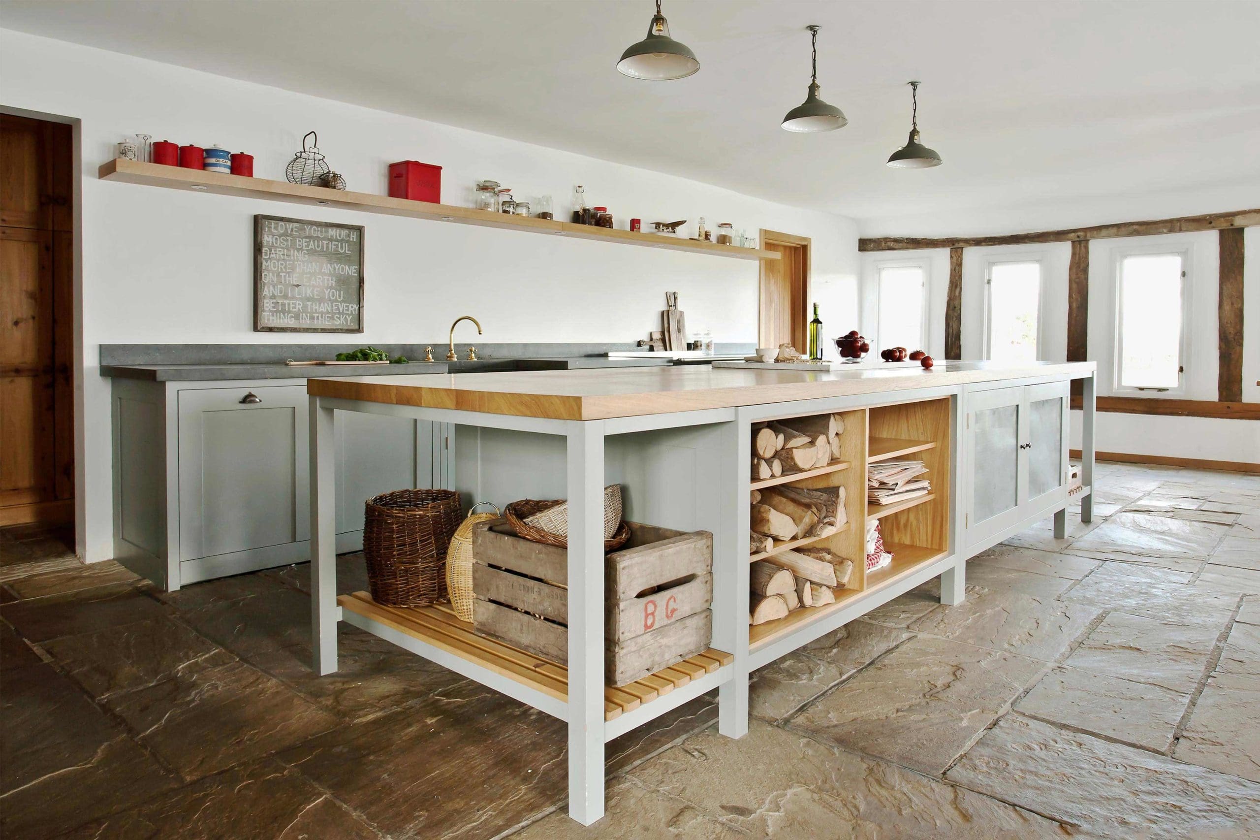  Hampshire Hop Kiln open plan kitchen with slate flooring, the Osea Island with oak lined open shelving and perforated zinc doors and custom made handcrafted cabinets. Long House. Slatted shelving. Georgian.