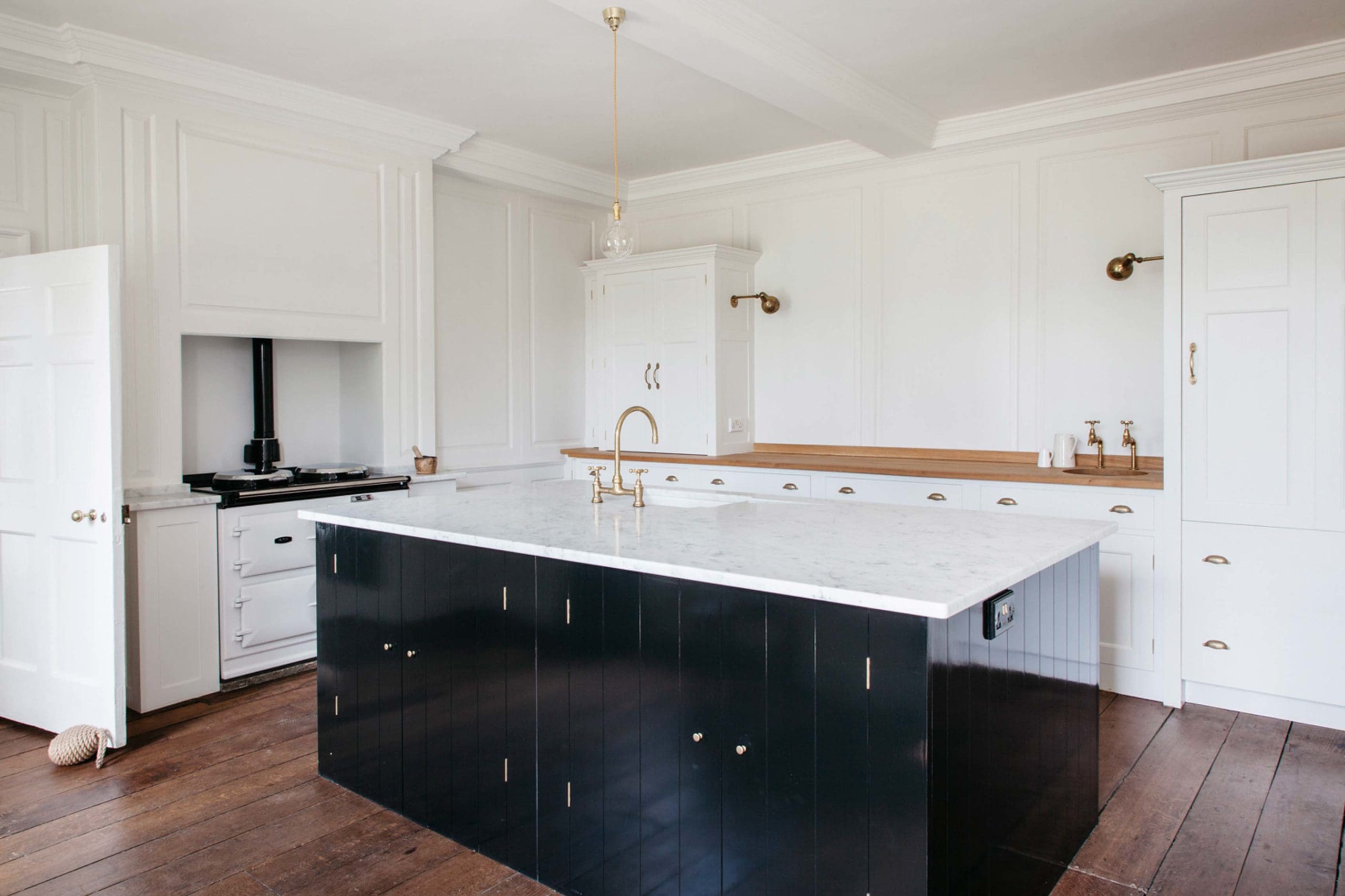  The Rectory Kitchen featuring Spitalfields cupboards with freestanding island with honed Carrara Marble worktop and boarded doors. Boarded End panels. Island gloss paint. Pull out drawers