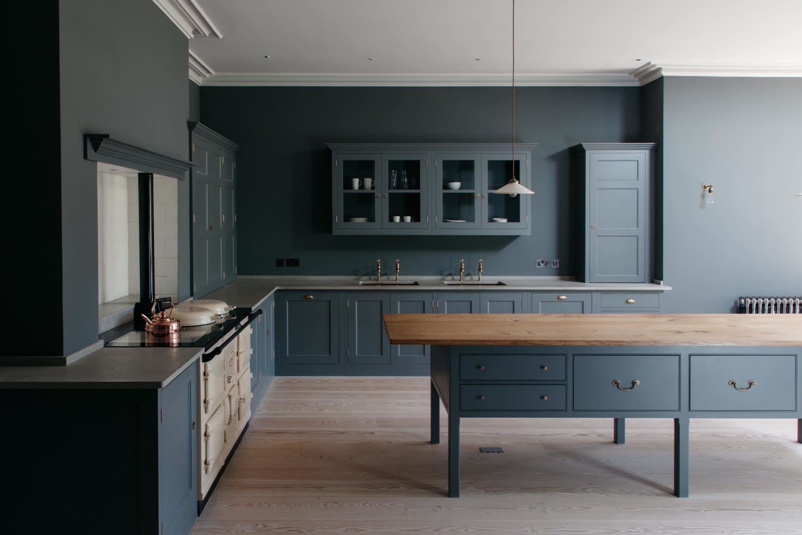  Dark blue kitchen with centre table work surface and Aga