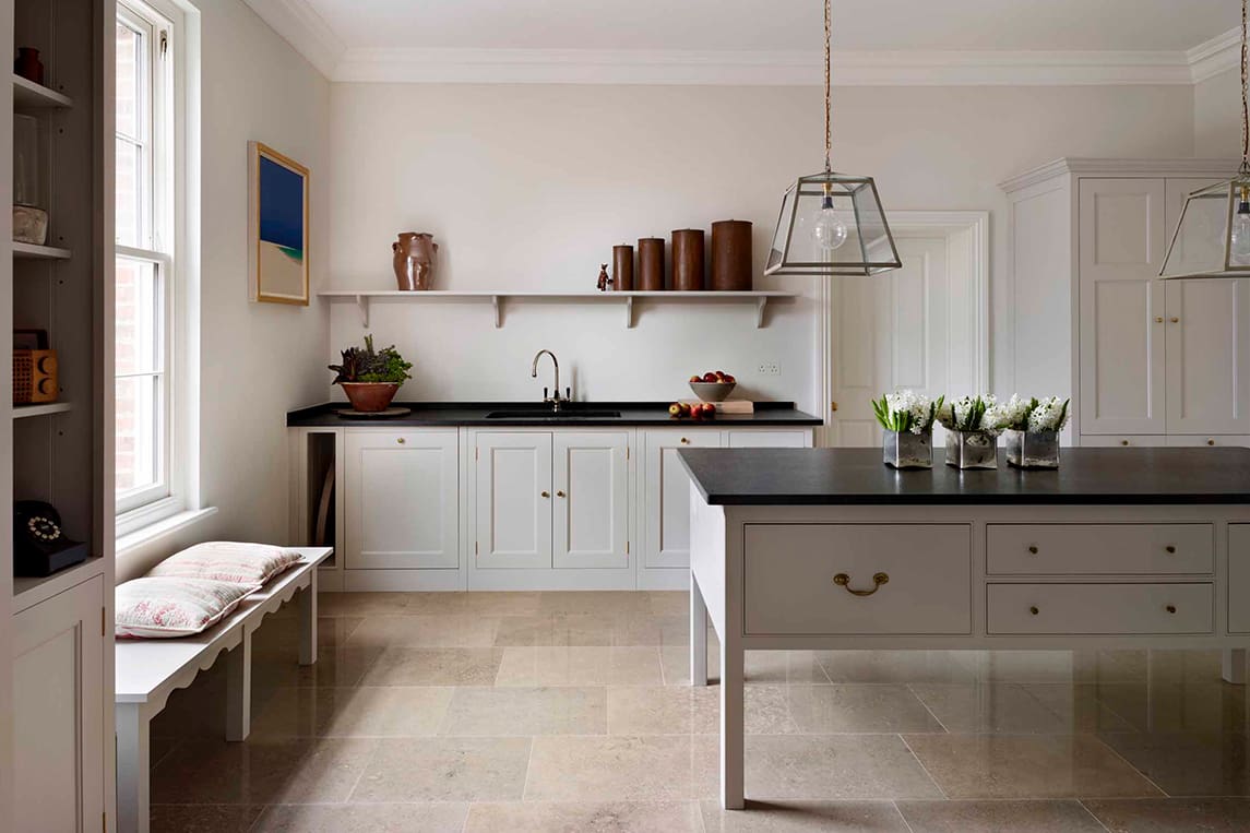  White wooden Lodge kitchen with black stone work surfaces
