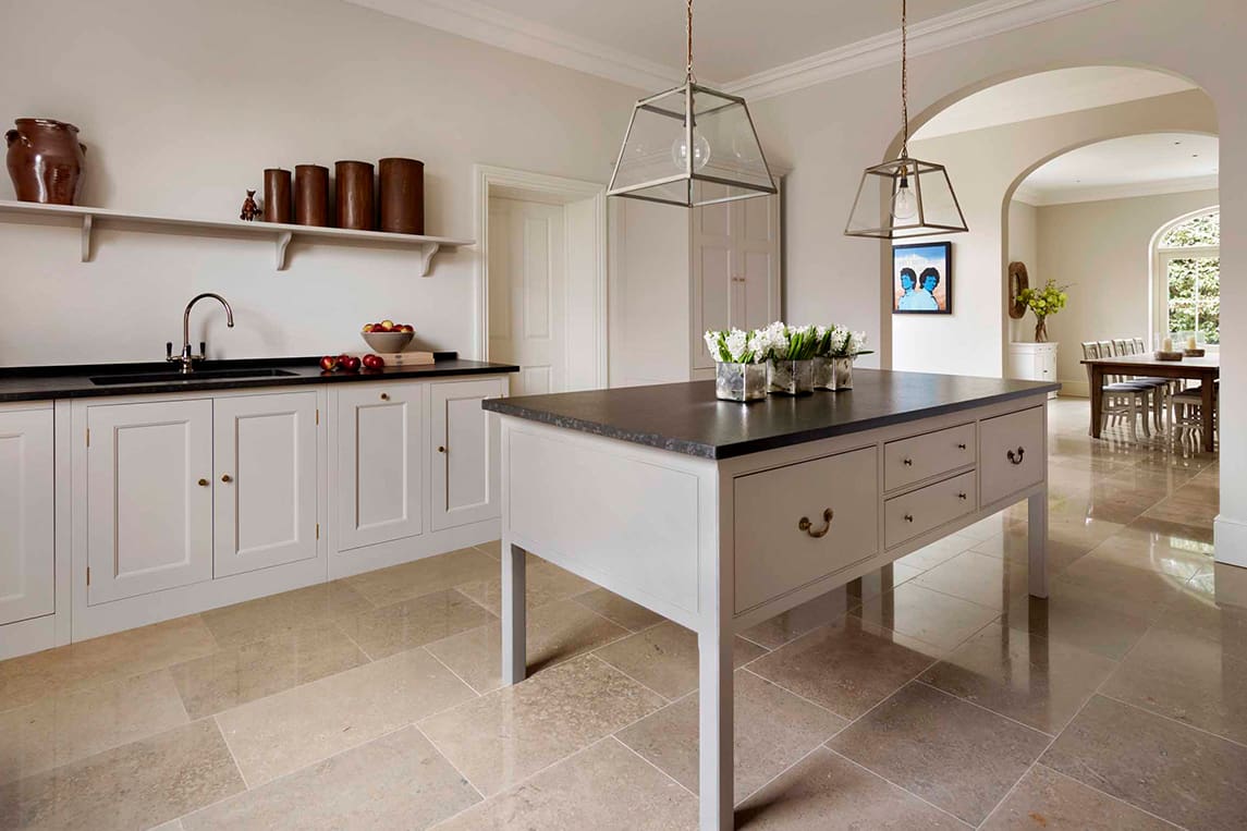  White wooden Lodge kitchen with black stone work surfaces