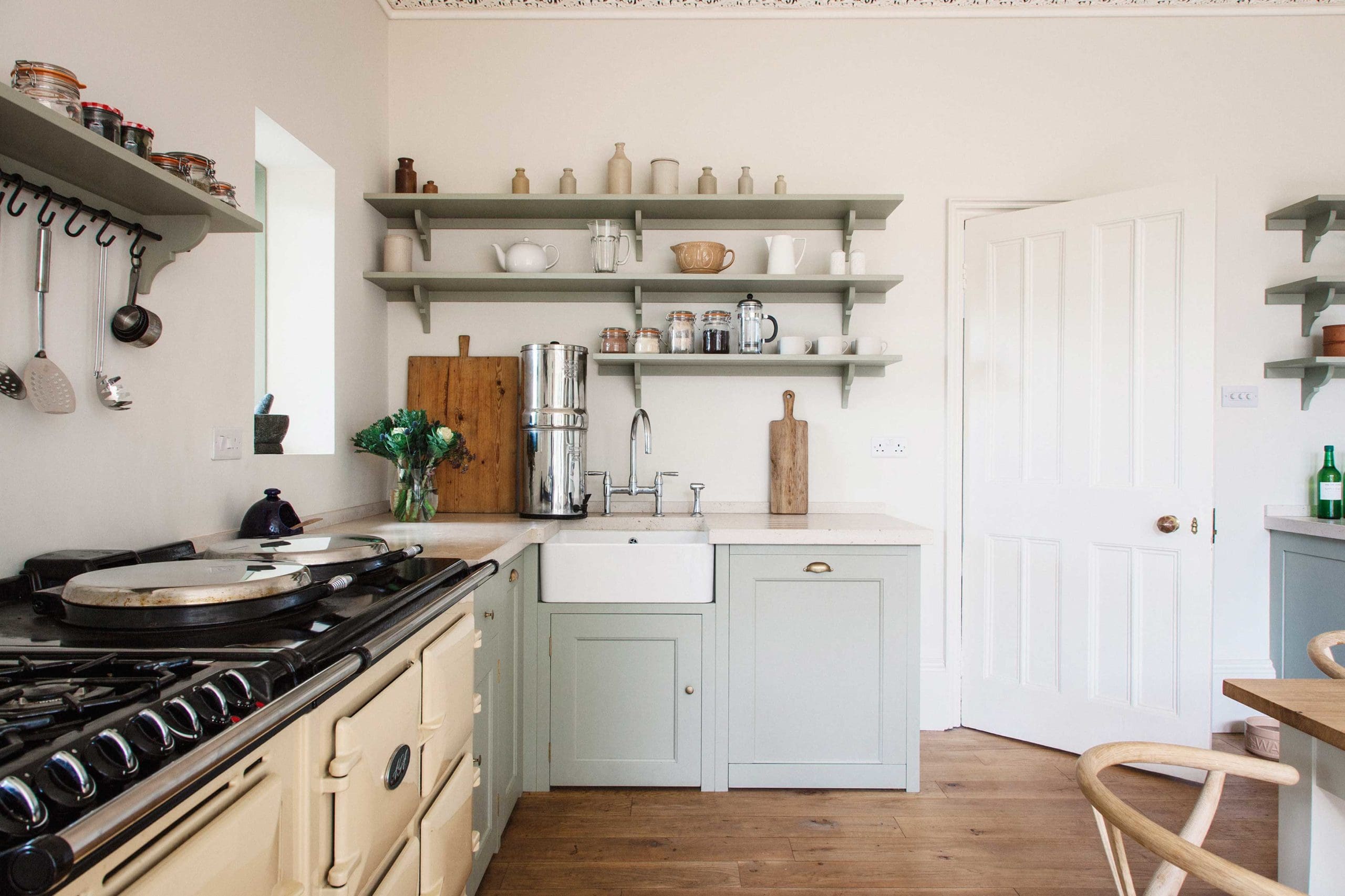  Light blue wooden kitchen units with cream Aga oven