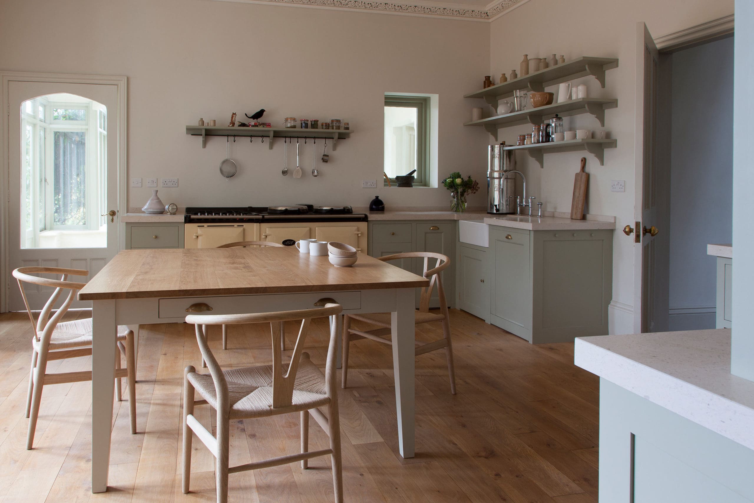  Light blue wooden kitchen with dining table
